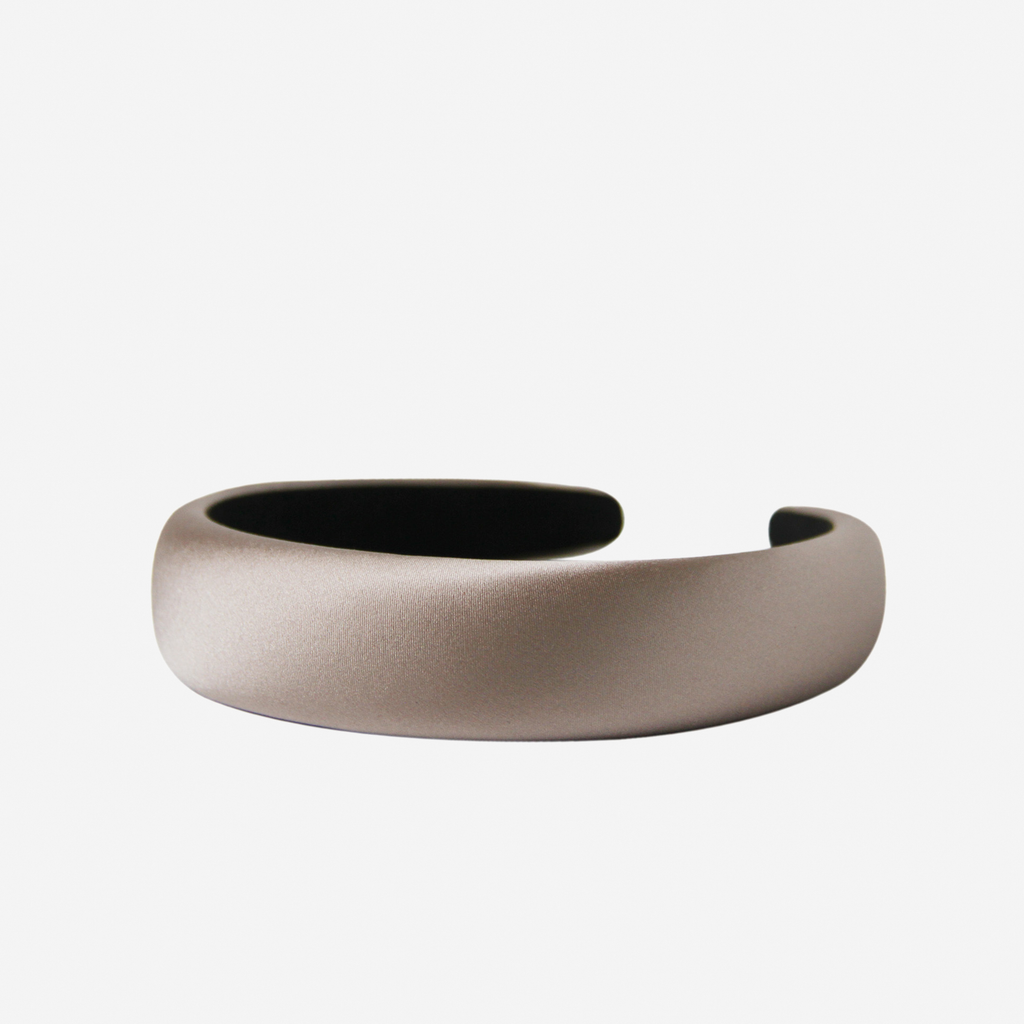 Taupe silk padded headband on an off white background