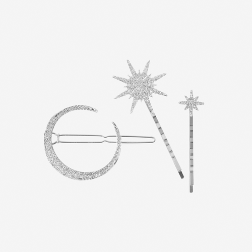 Set of 3 silver and crystal star and moon hair clips on an off white background