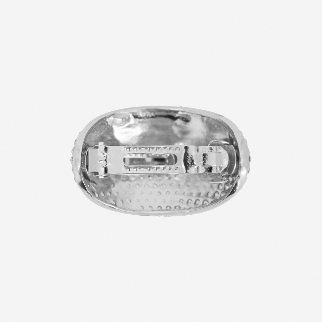 Oval silver and crystal pave ponytail holder,  back view showing the fastening, on an off white background