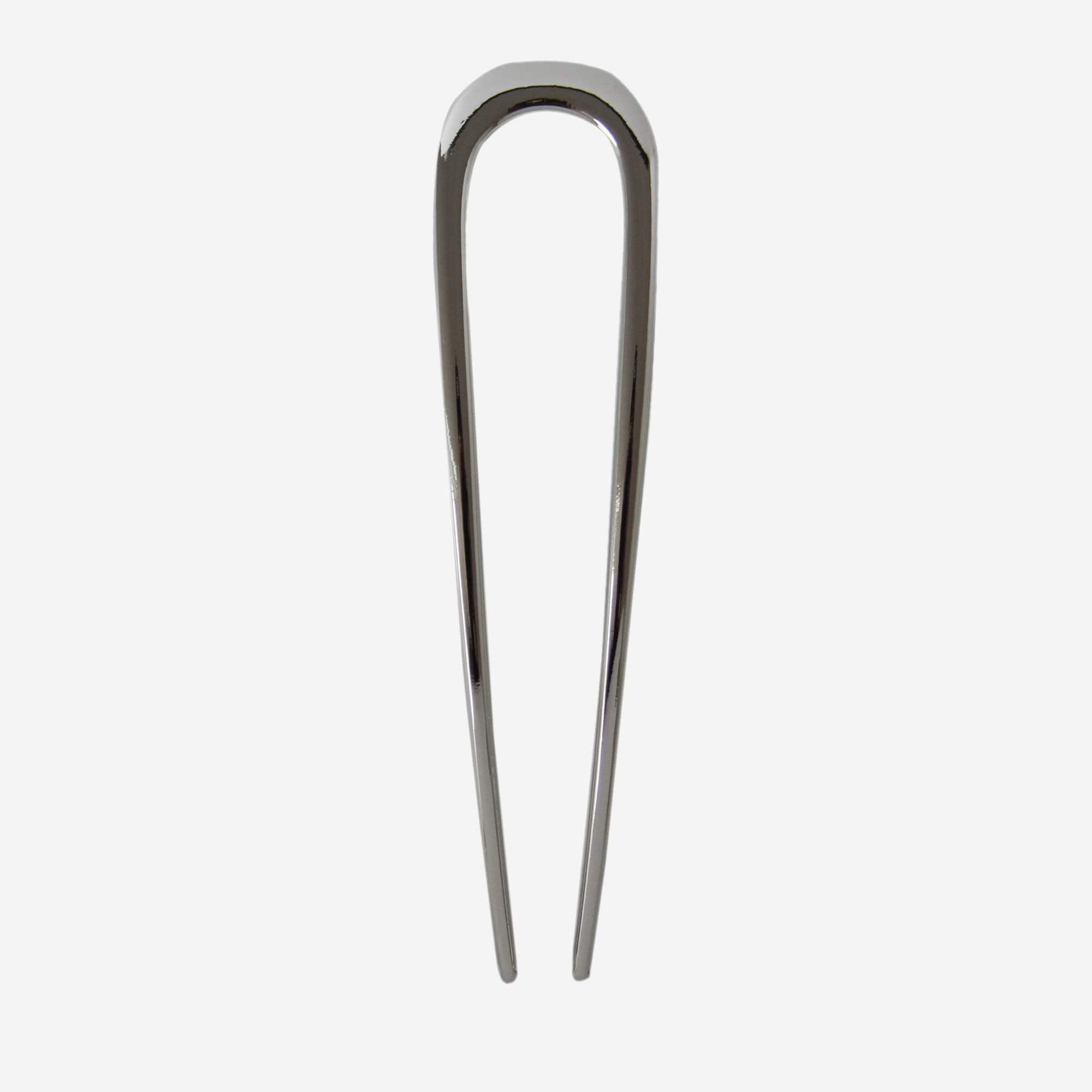 Silver metal french hair pin on an off white background