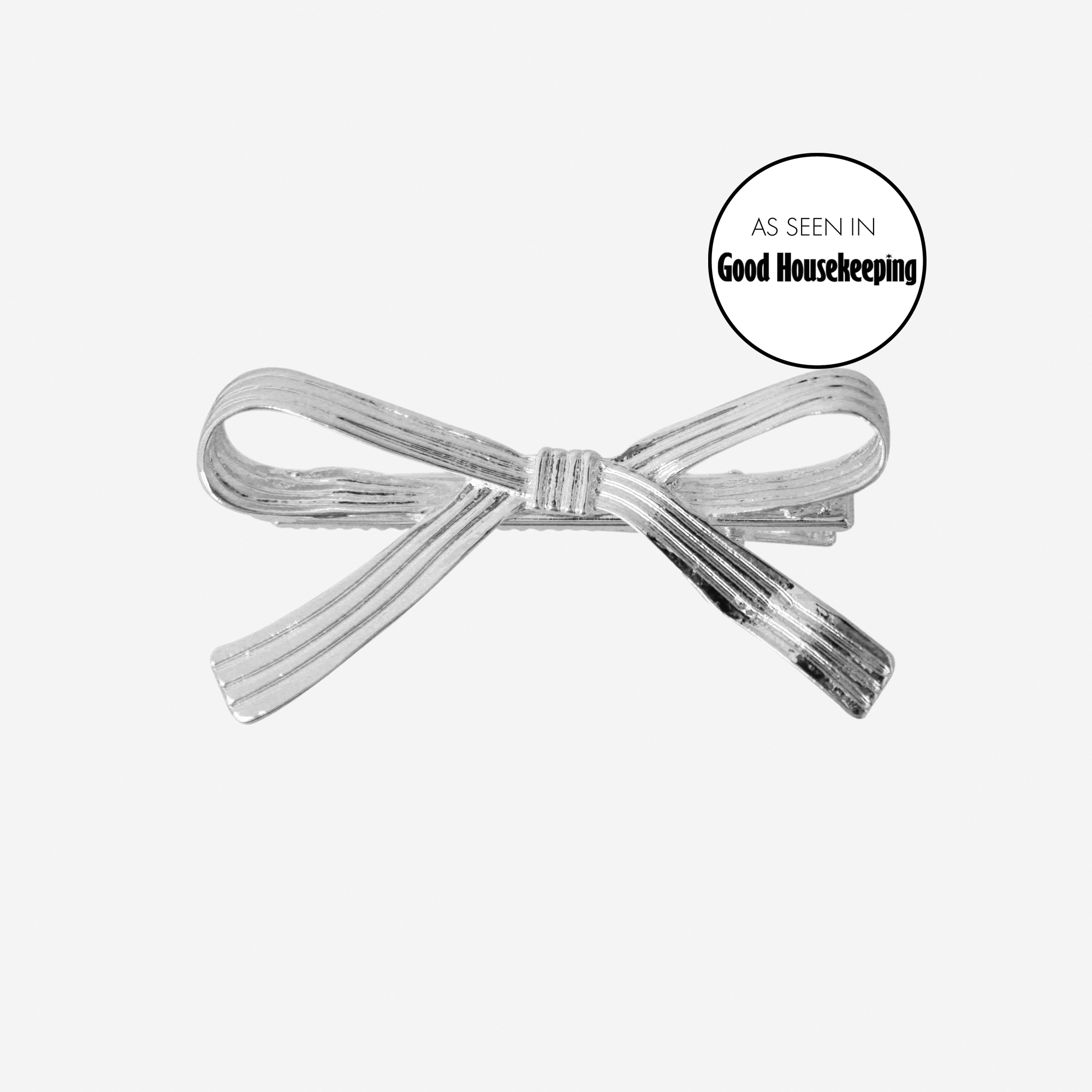 Silver ribbon hair clip, featuring an as seen in good housekeeping logo, on an off white background