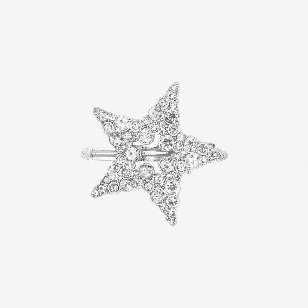 Silver and crystal hair clip on an off white background
