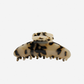 Light Tortoiseshell oval hair claw on an off white background