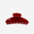Red oval hair claw on an off white background
