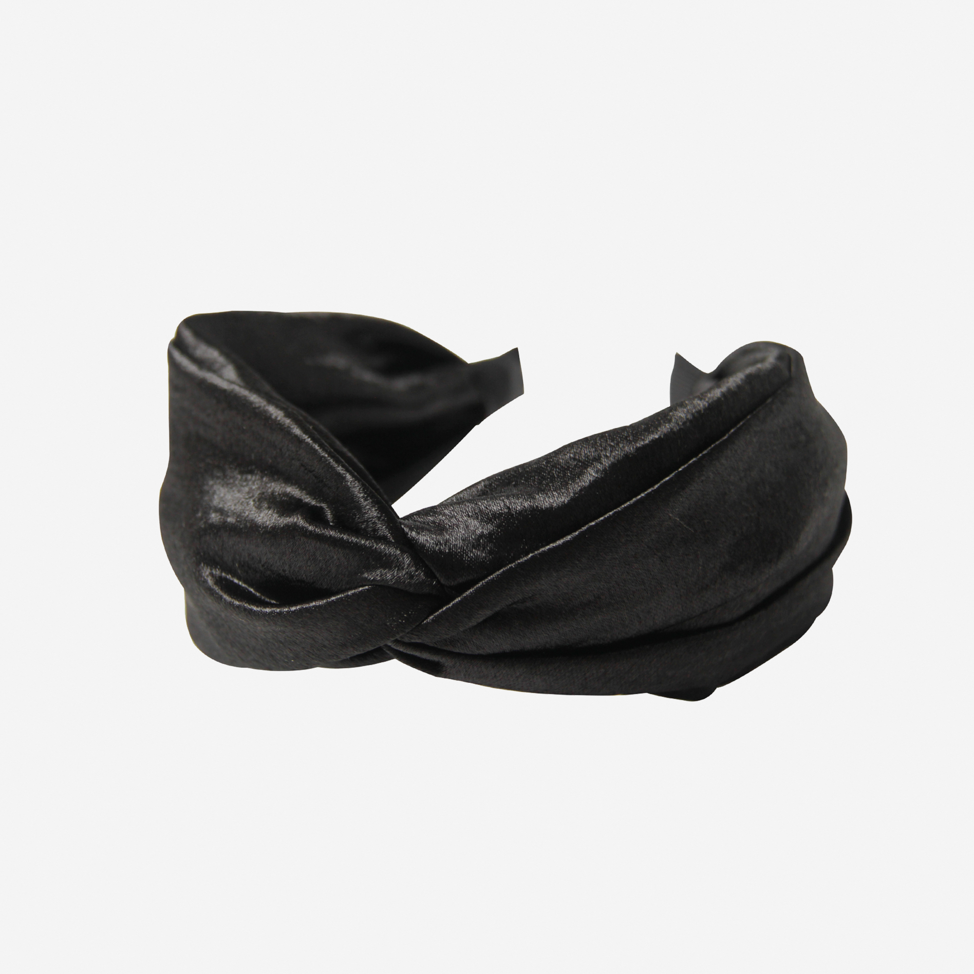 Black twist headband on an off white background
