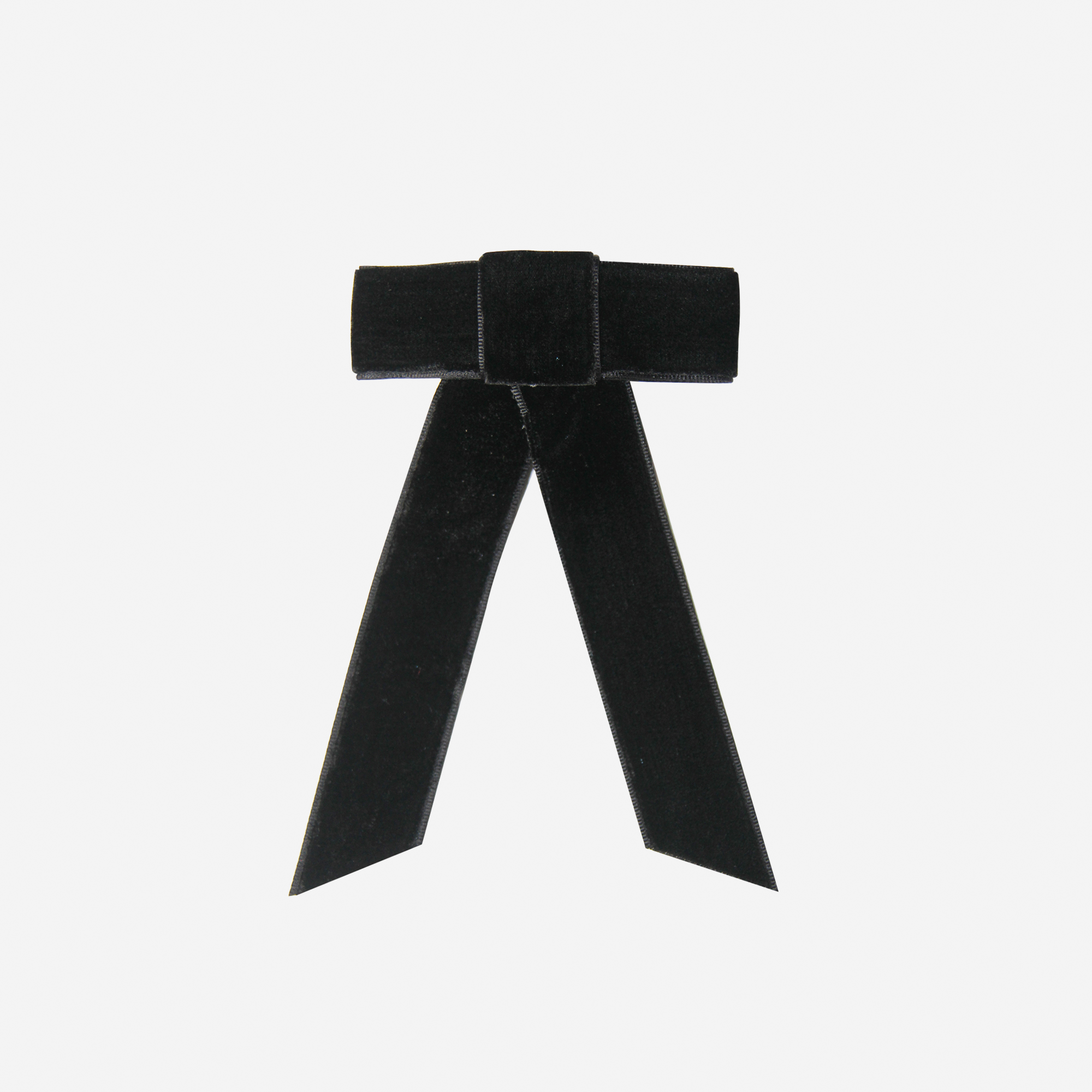 Black velvet hair bow on an off white background