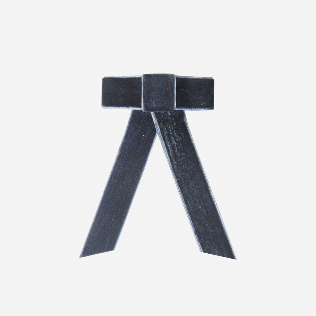 Navy Blue velvet hair bow on an off white background