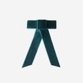 Teal velvet hair bow on an off white background