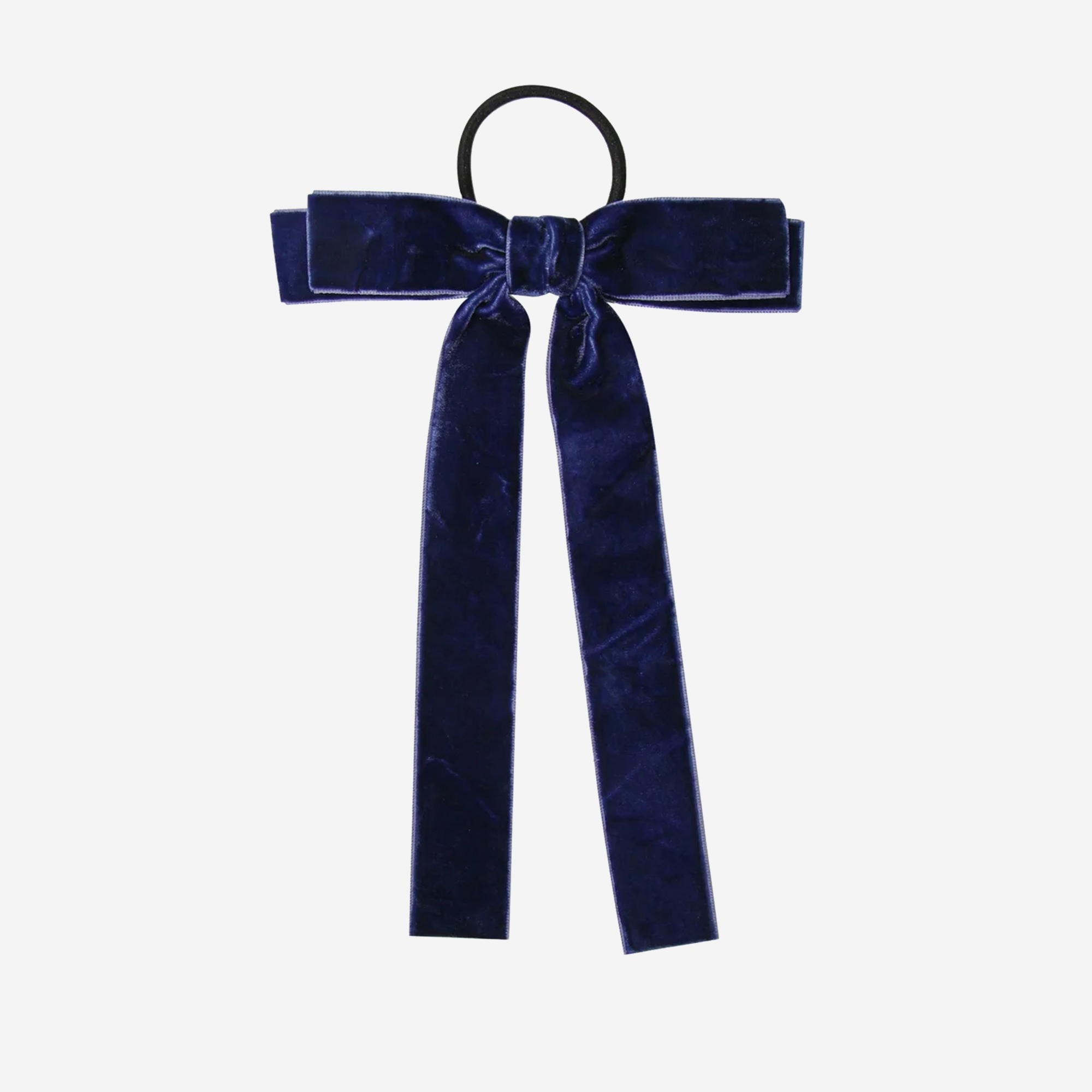 Navy blue velvet hair bow on an off white background