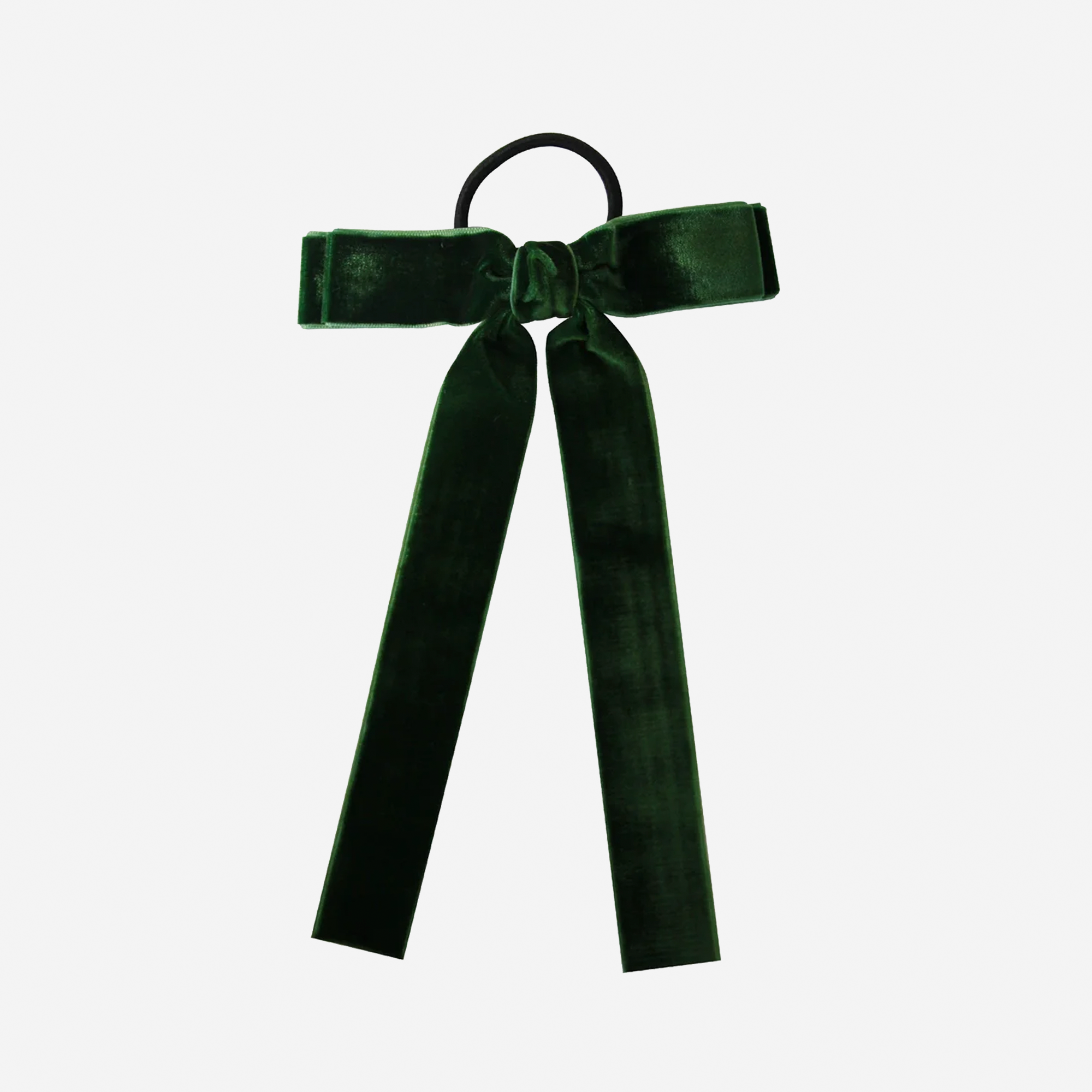Green velvet bow hair tie on an off white background