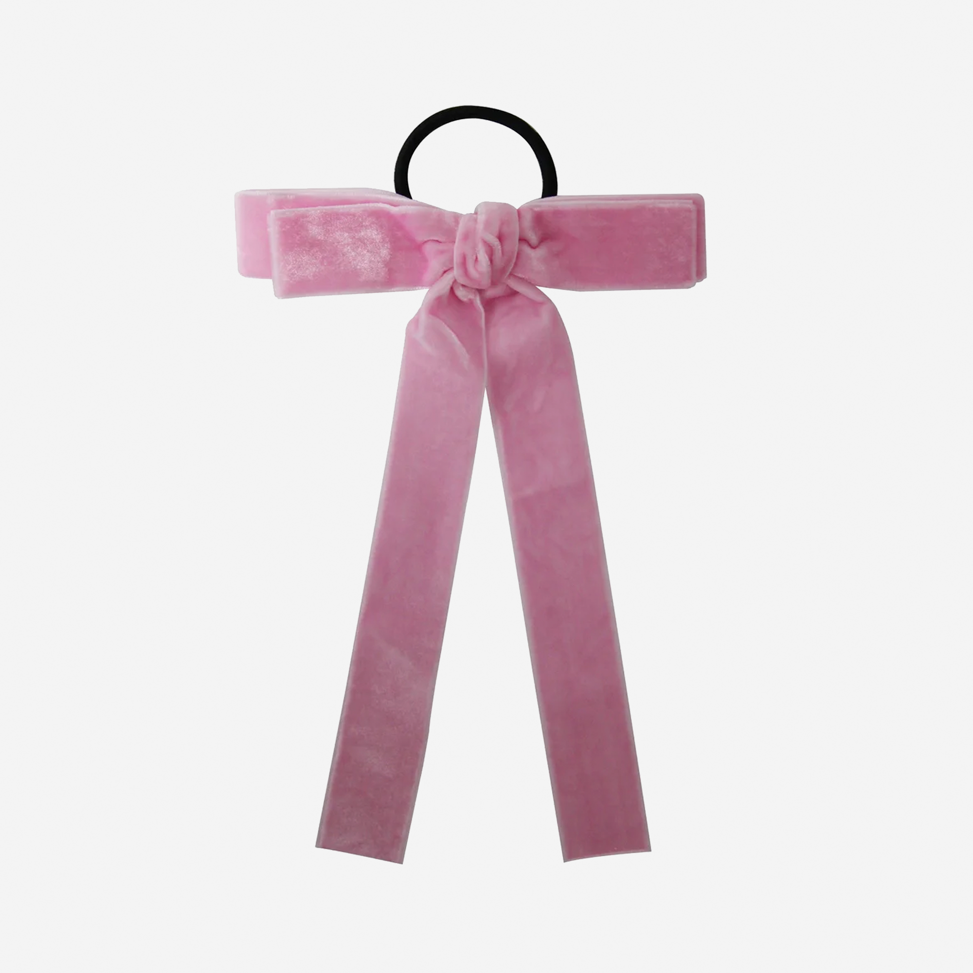 Pink velvet bow hair tie on an off white background