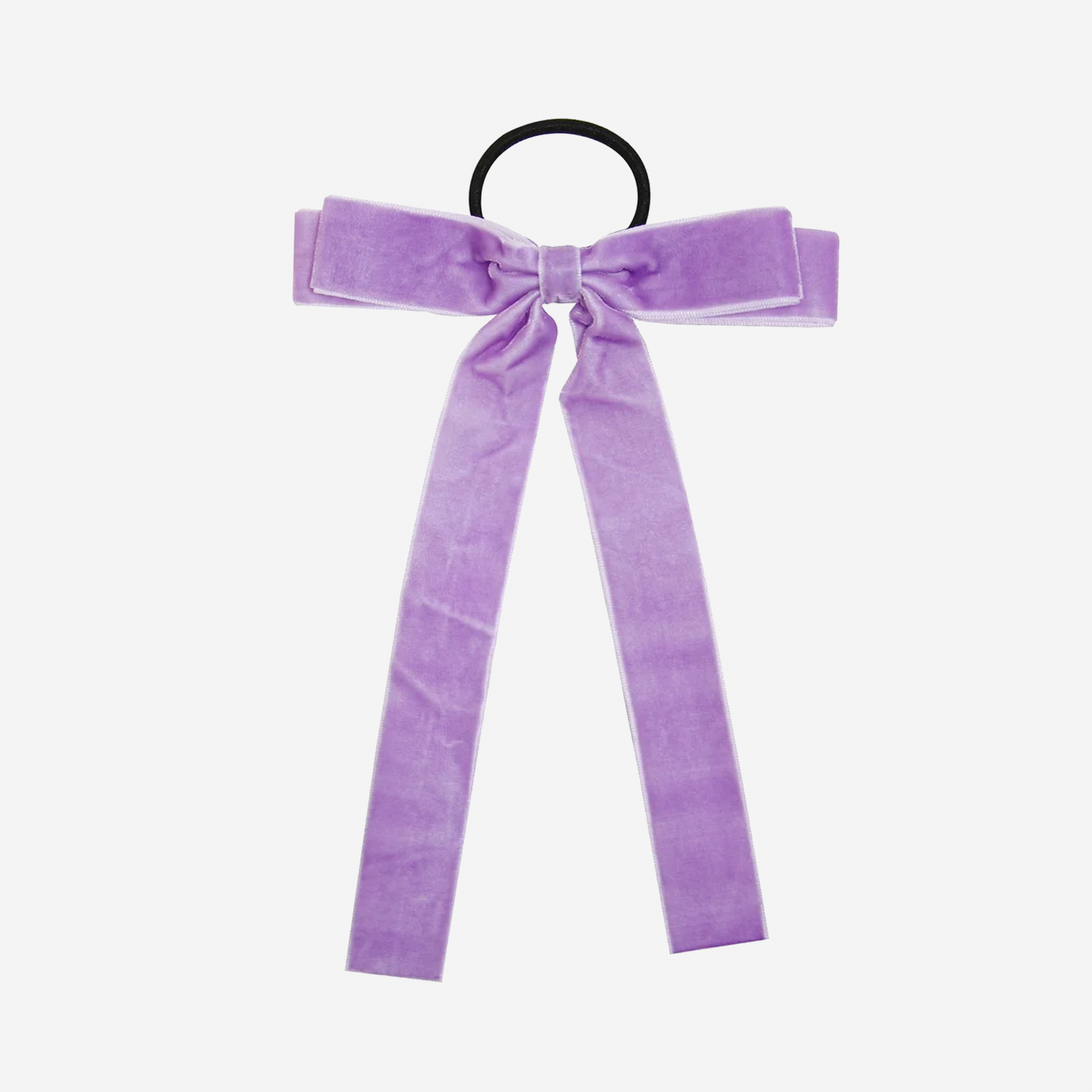 Purple velvet bow hair tie on an off white background
