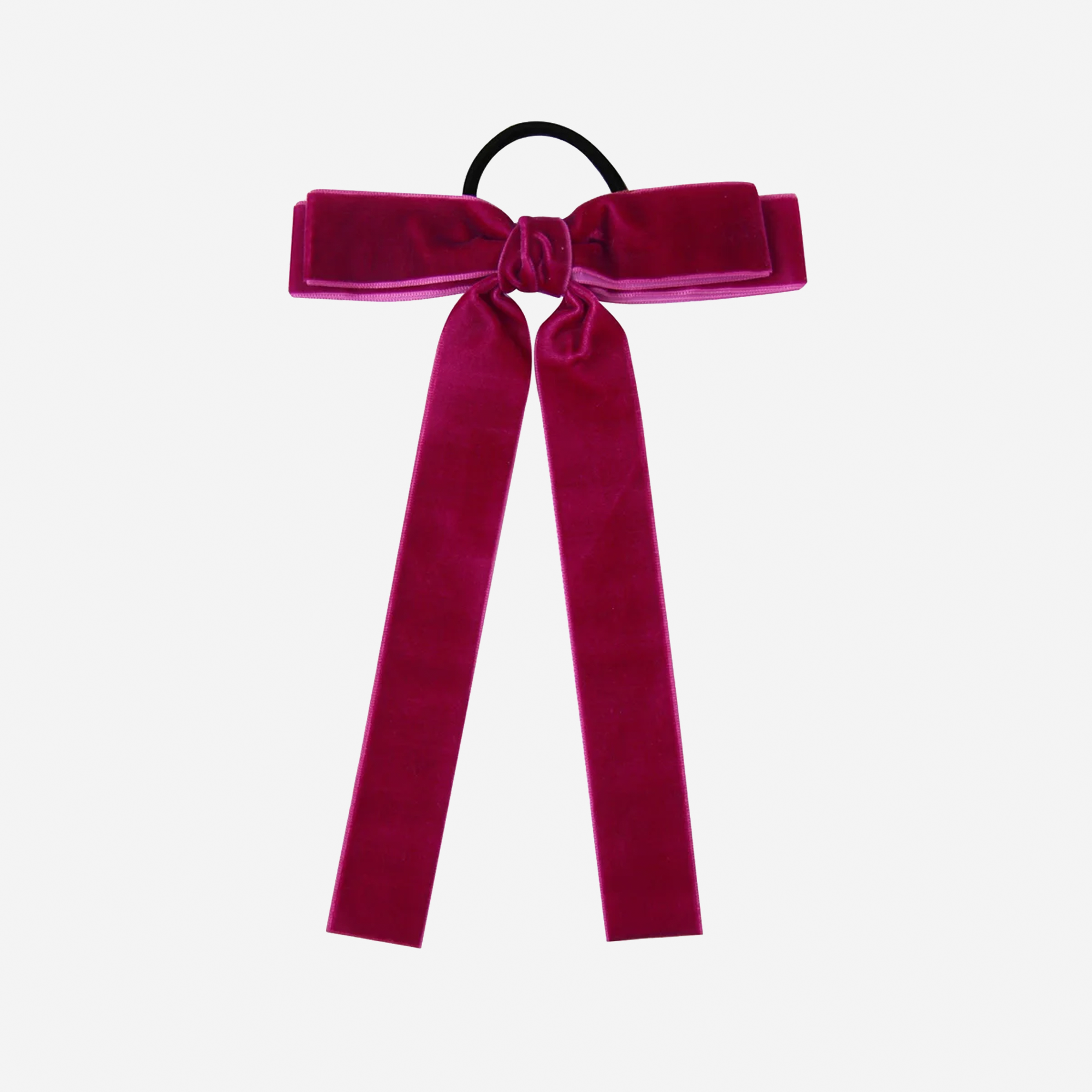 Raspberry velvet bow hair tie on an off white background