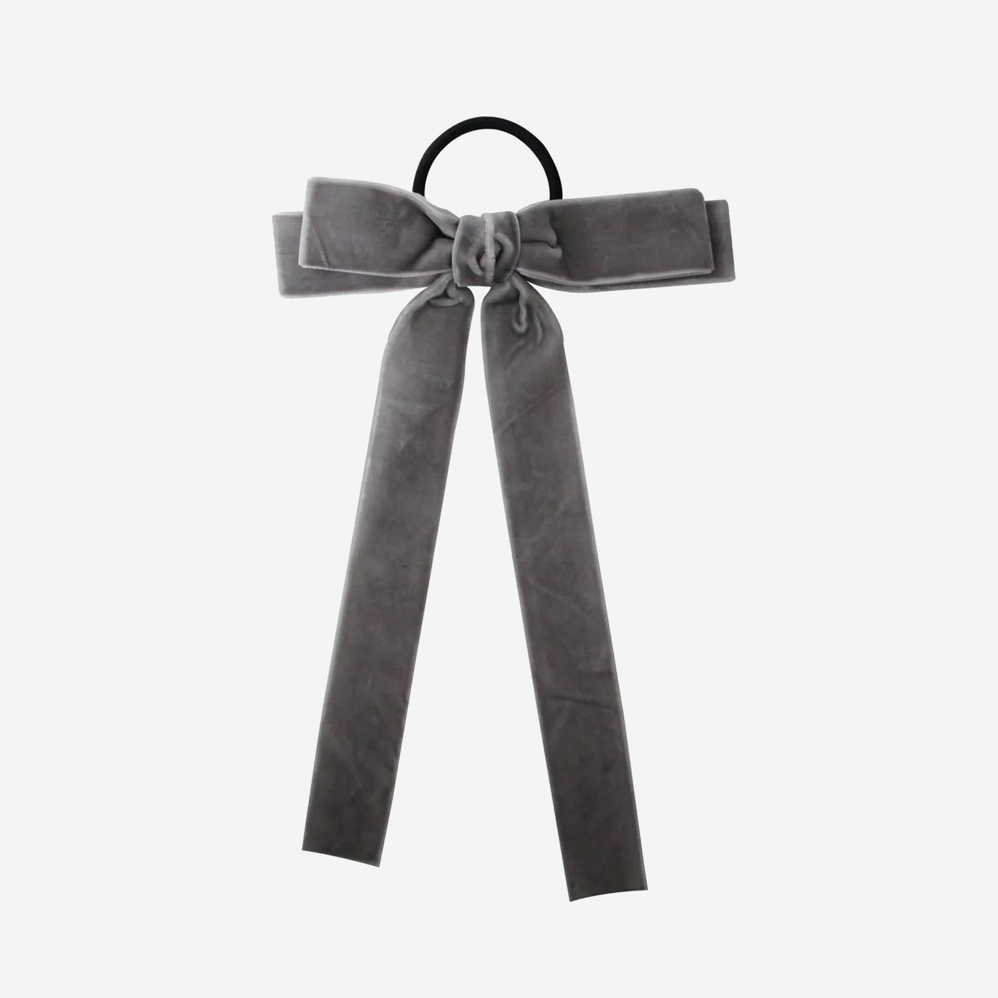 Grey velvet bow hair tie on an off white background