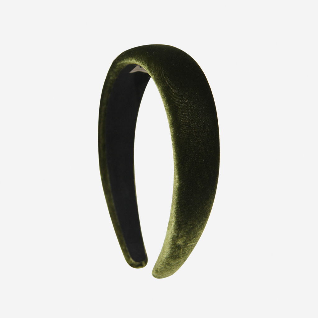 Green silk velvet padded headband on an off white background