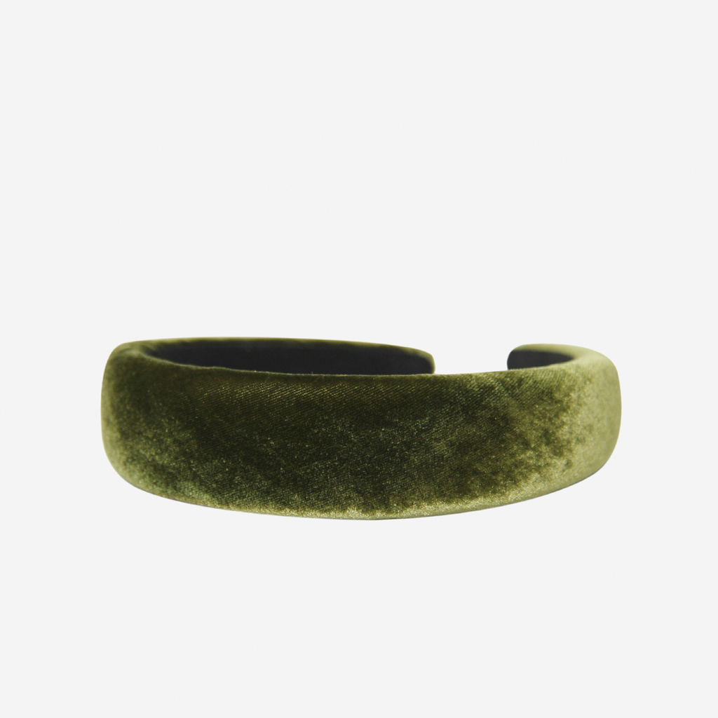 Green silk velvet padded headband on an off white background