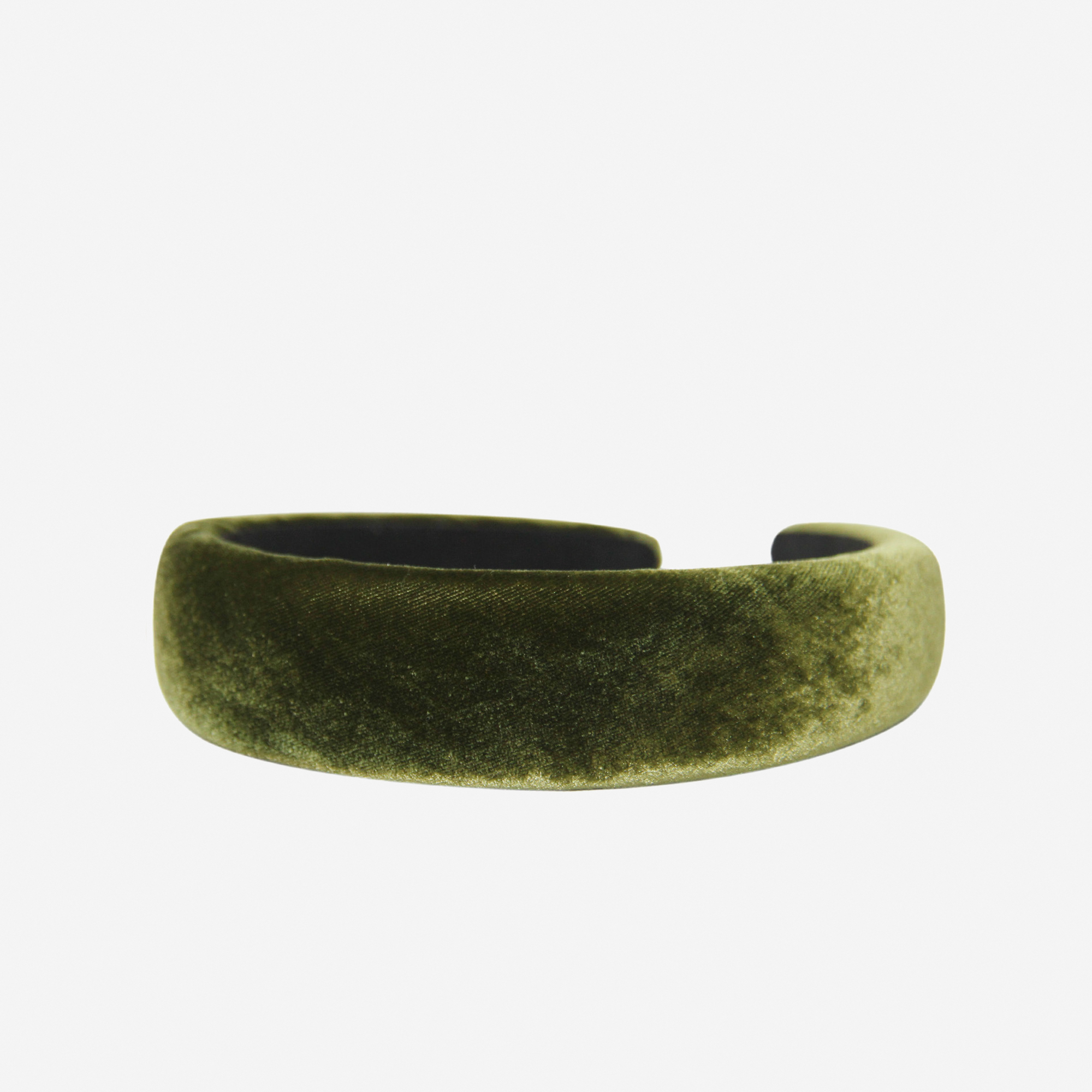 Green silk velvet padded headband on an off white background