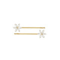 Two gold and crystal flower hair slides on a white background
