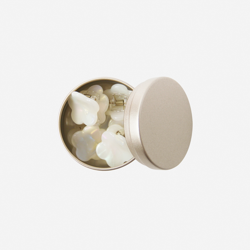 Set of 6 mother of pearl flower shaped mini hair claws in a gold tin