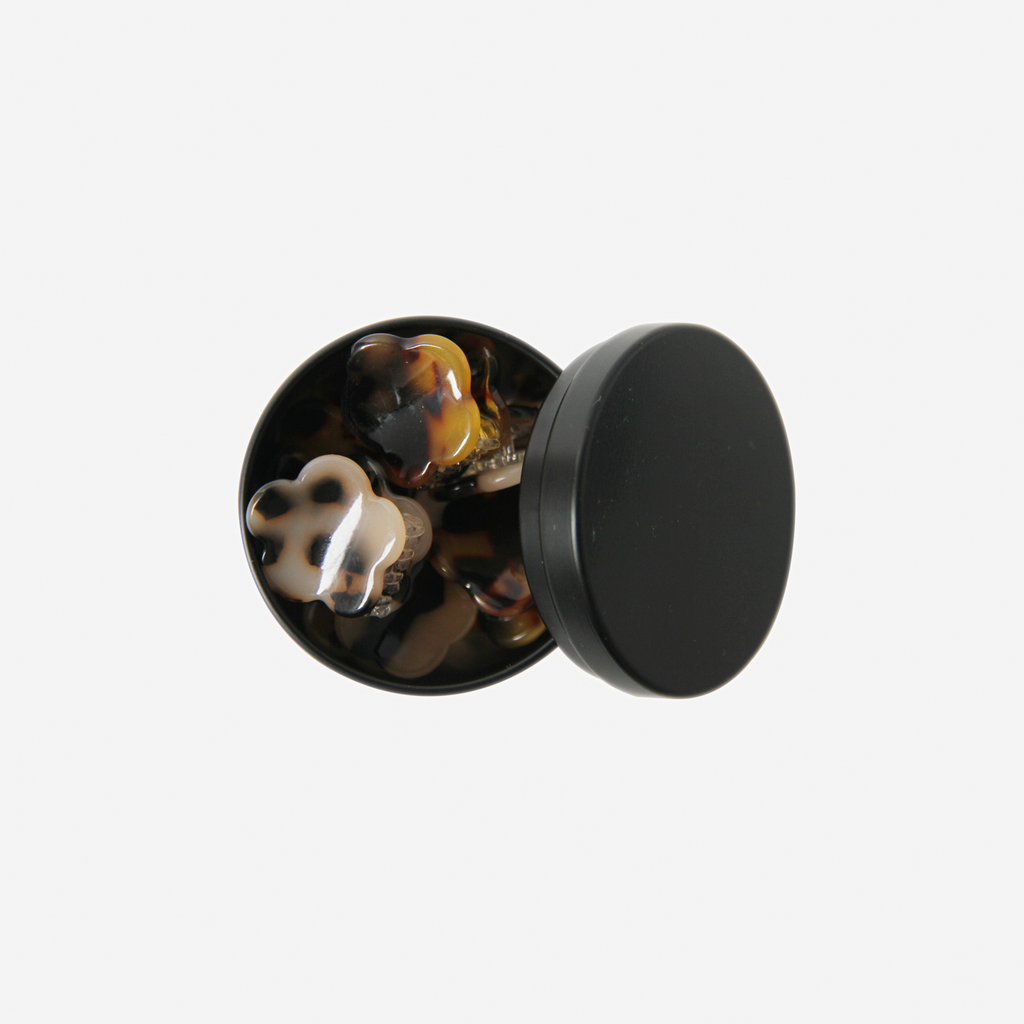 Set of 6 tortoiseshell flower shaped mini hair claws in a black tin
