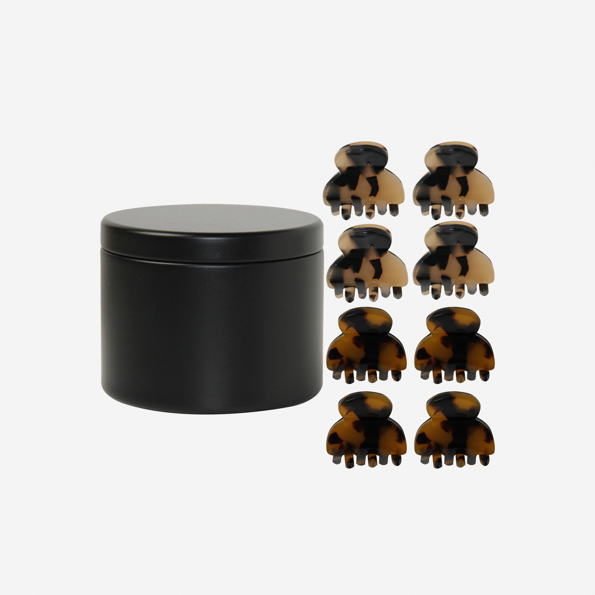 Set of 8 tortoisehell mini hair claws next to a keepsake black tin that they come packaging in
